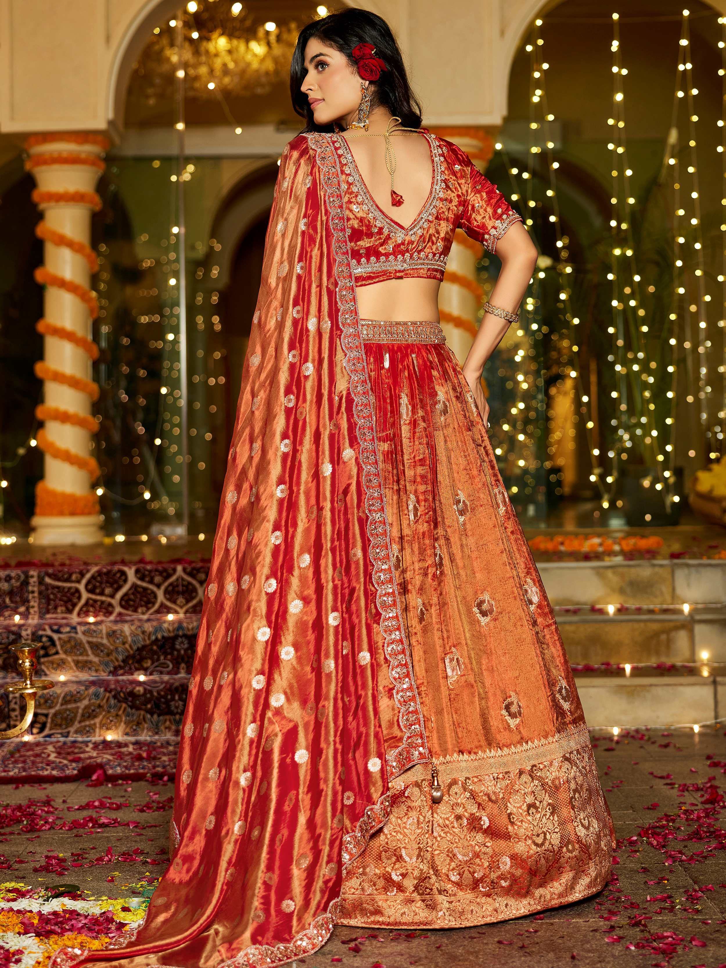 Attractive Orange Zari Weaving Tissue Engagement Wear Lehenga Choli