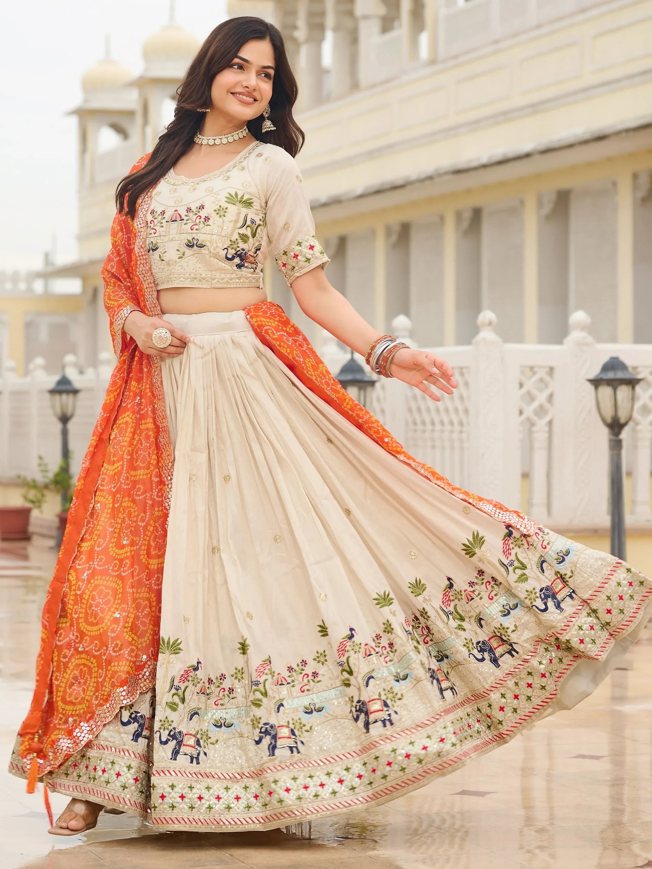 Majestic Off-White Sequnis Silk Lehenga Choli With Orange Dupatta