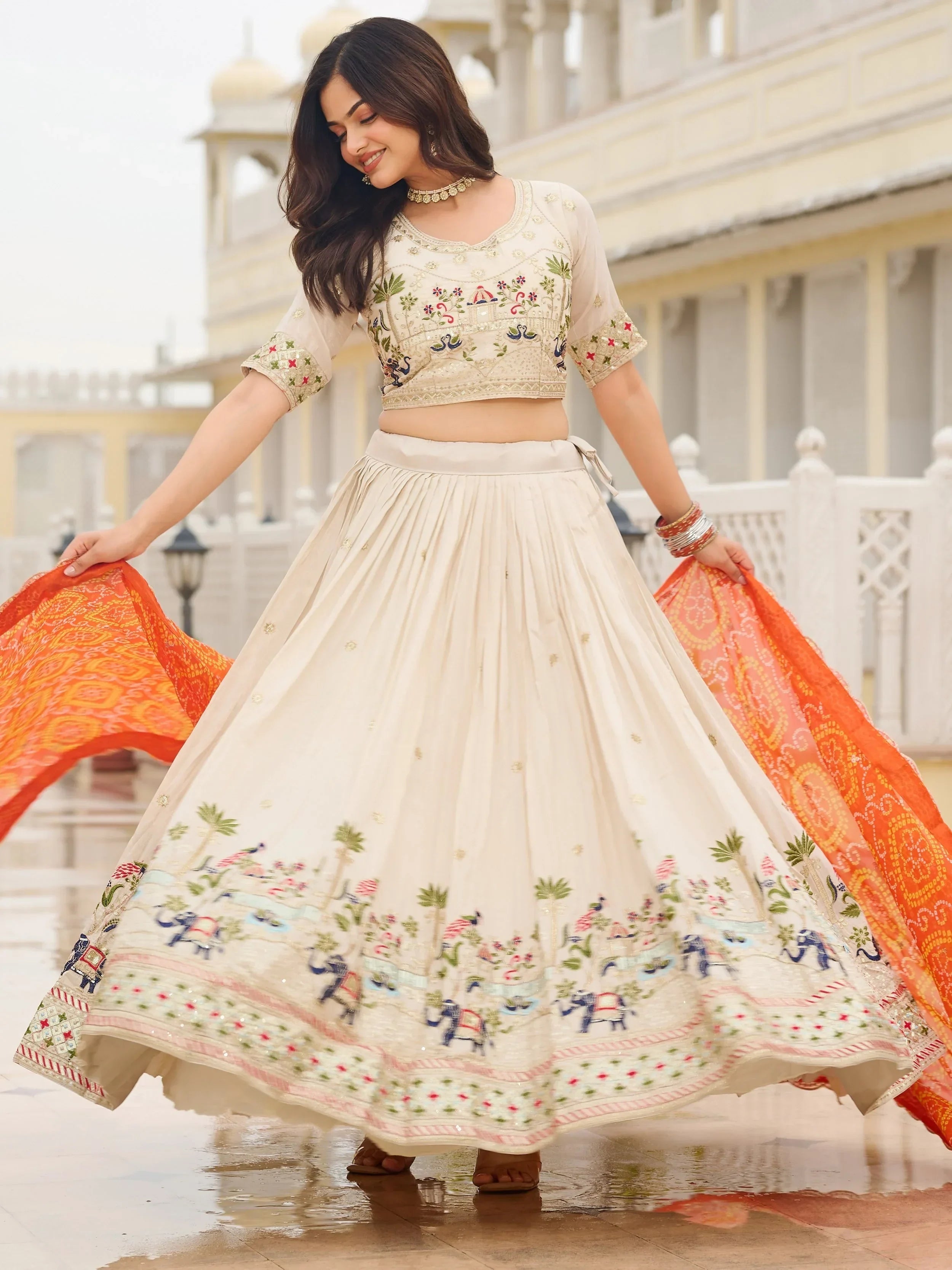 Majestic Off-White Sequnis Silk Lehenga Choli With Orange Dupatta