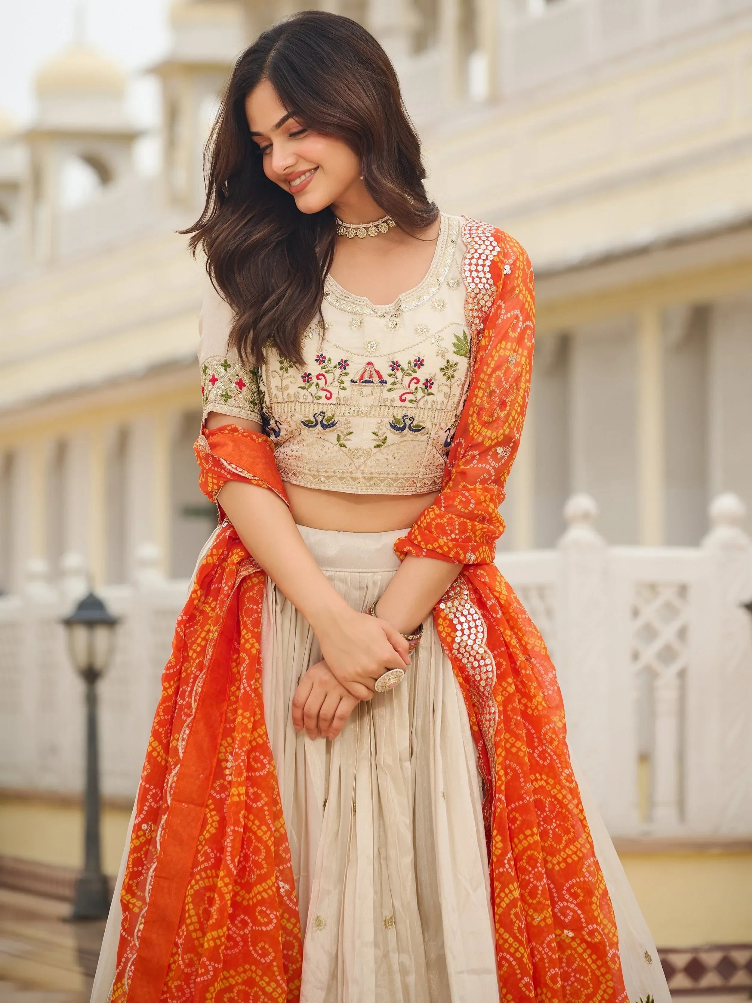 Majestic Off-White Sequnis Silk Lehenga Choli With Orange Dupatta