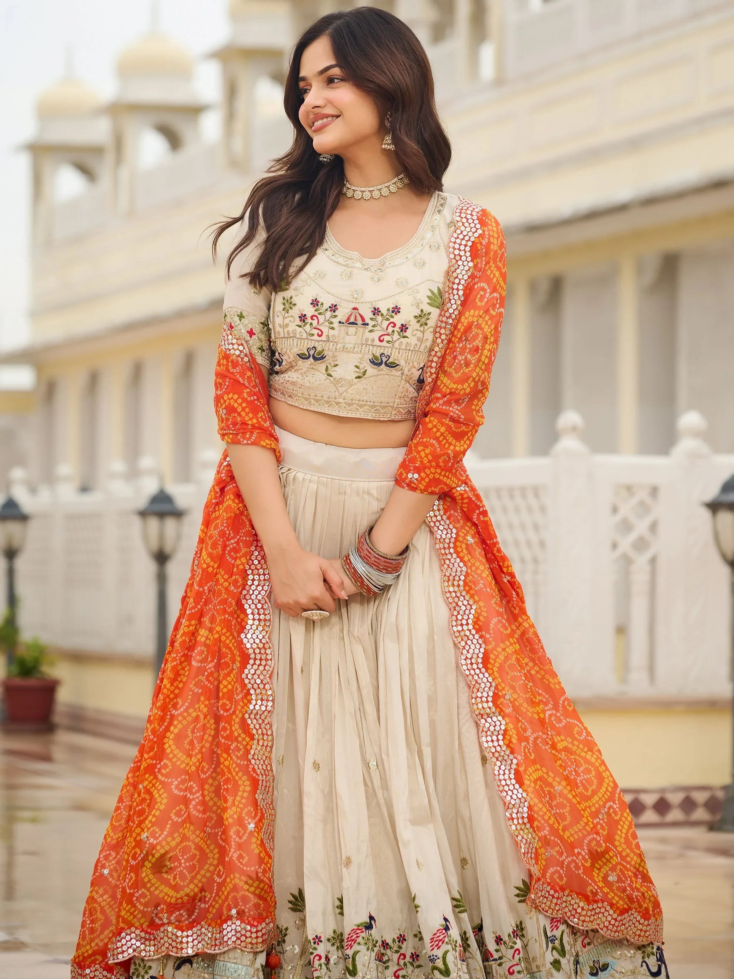 Majestic Off-White Sequnis Silk Lehenga Choli With Orange Dupatta