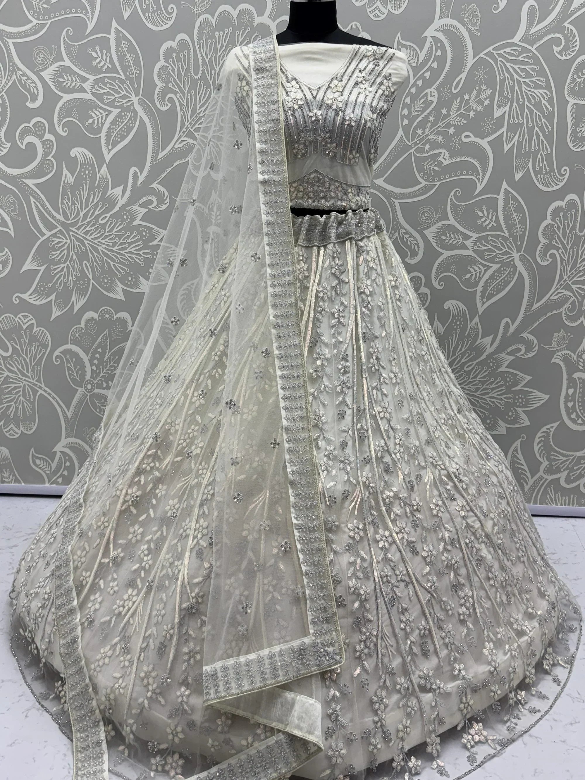 Beautiful White Sequins Embroidered Net Reception Wear Lehenga Choli