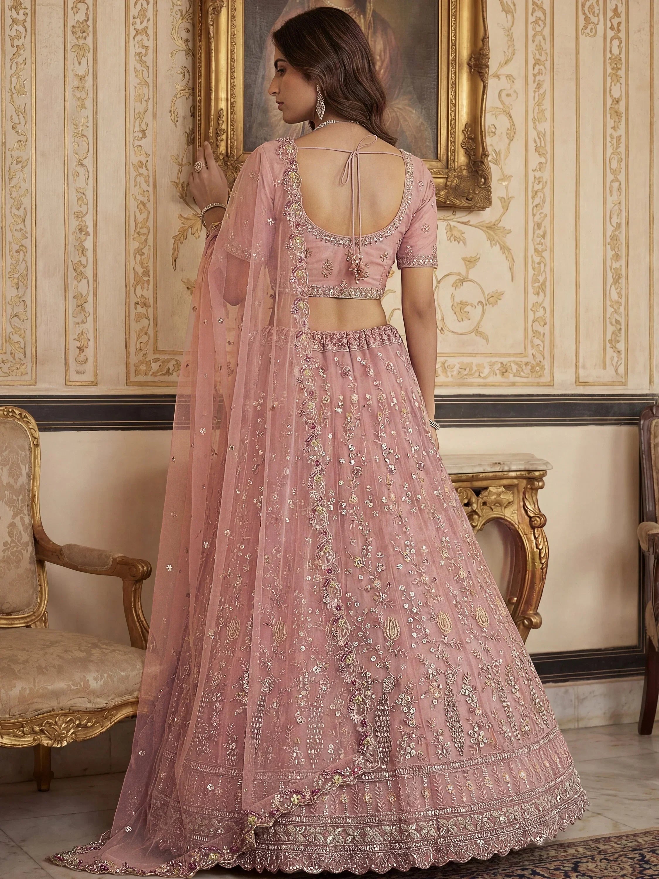 Peach Gorgeous Embroidered Net Engagement Wear Lehenga Choli