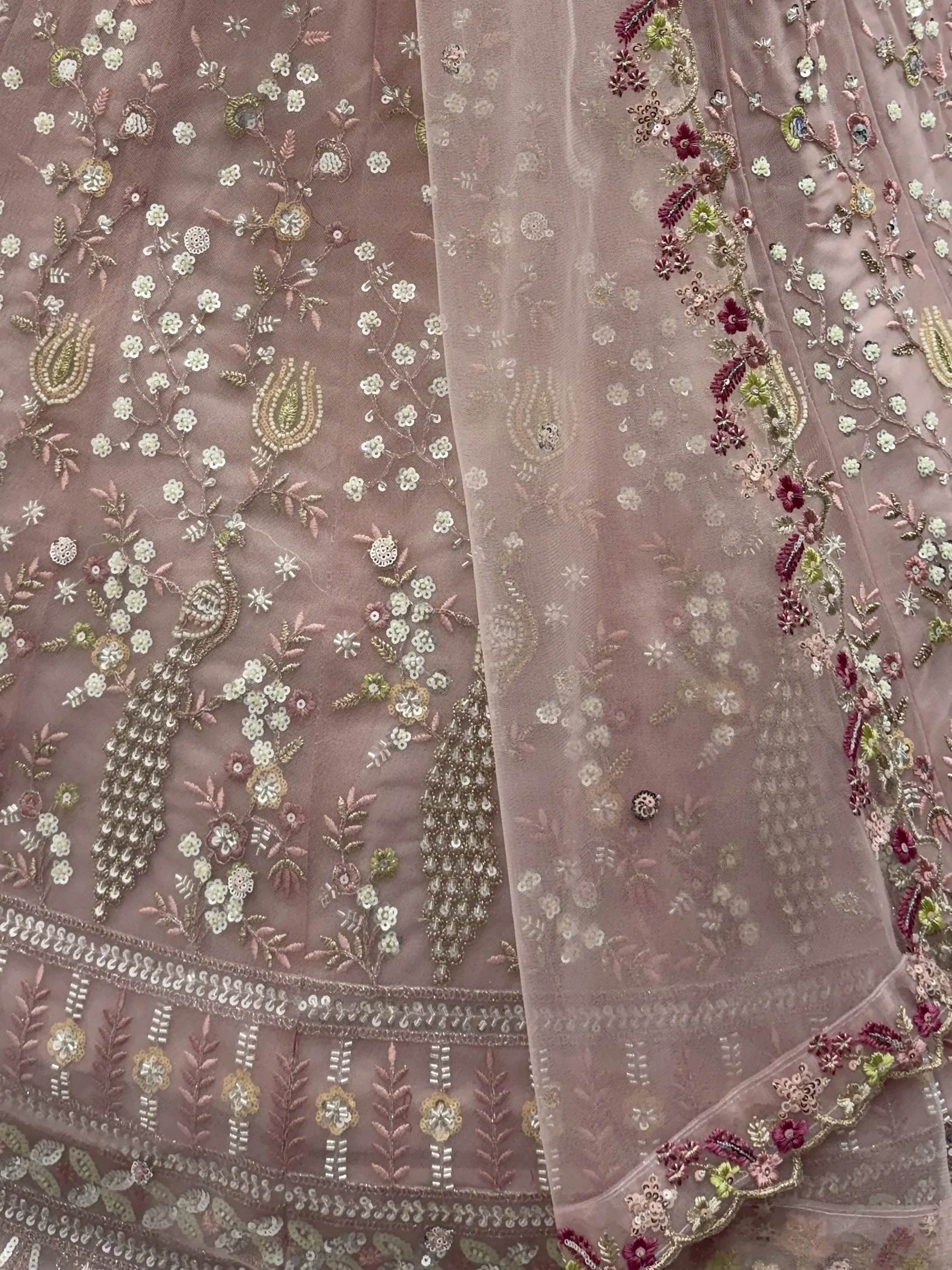 Peach Gorgeous Embroidered Net Engagement Wear Lehenga Choli