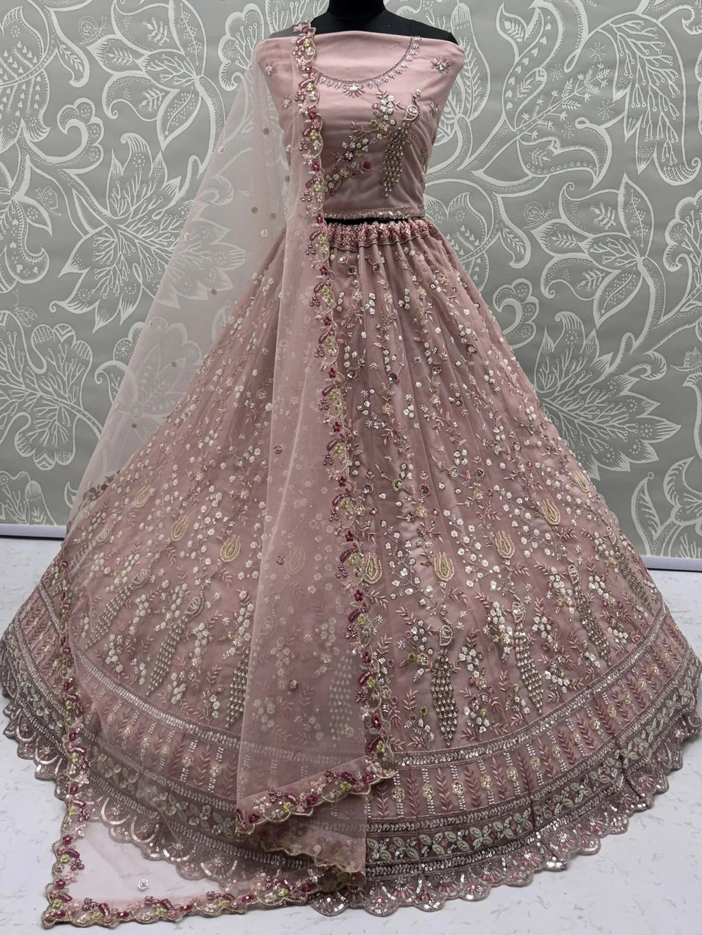 Peach Gorgeous Embroidered Net Engagement Wear Lehenga Choli