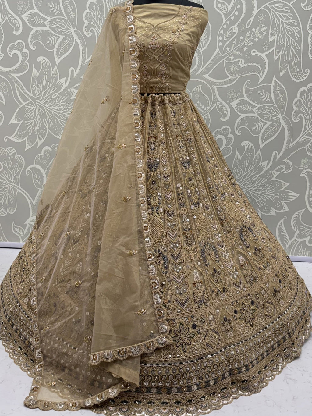 Beige Shiny Embroidered Net Reception Wear Lehenga Choli With Dupatta
