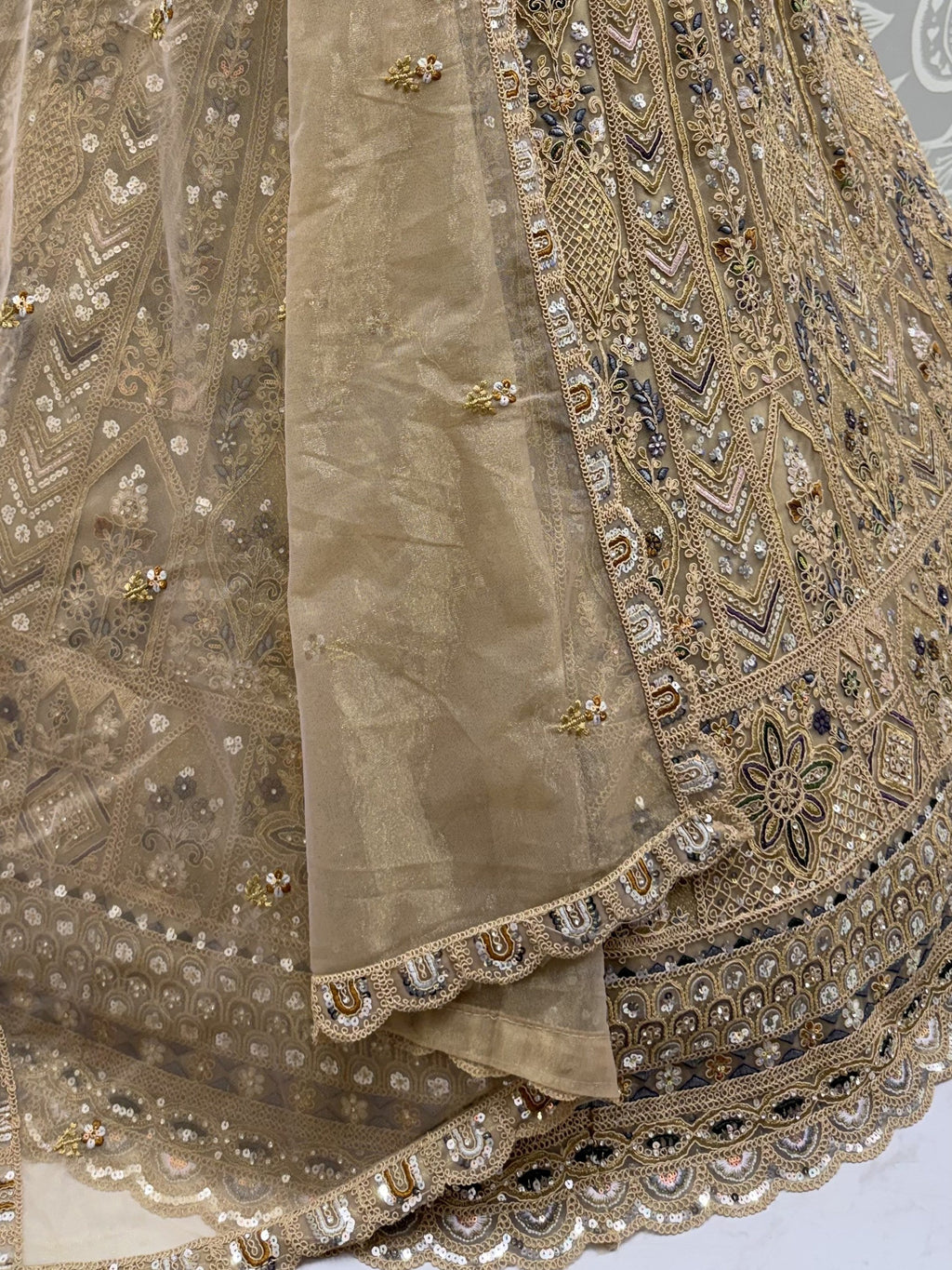 Beige Shiny Embroidered Net Reception Wear Lehenga Choli With Dupatta