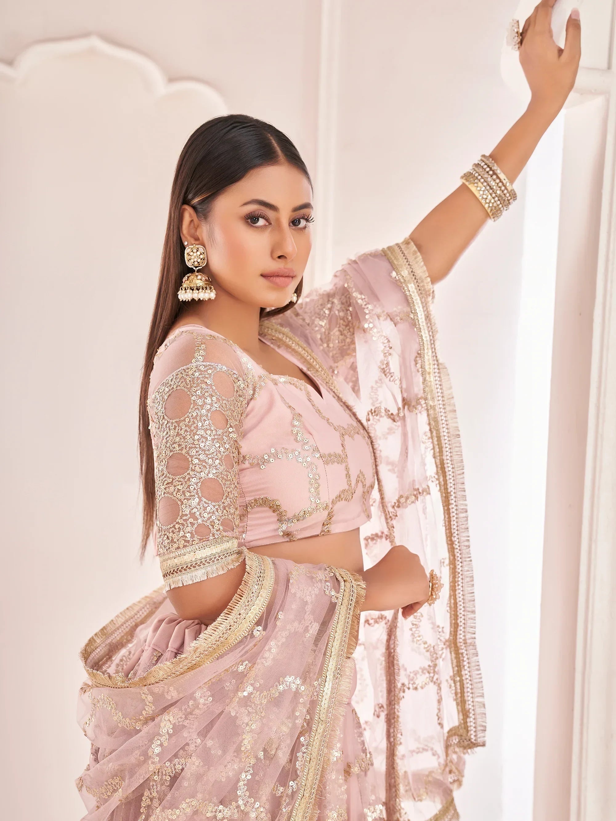 Prominent Pastel Pink Sequins Embroidery Net Lehenga Choli