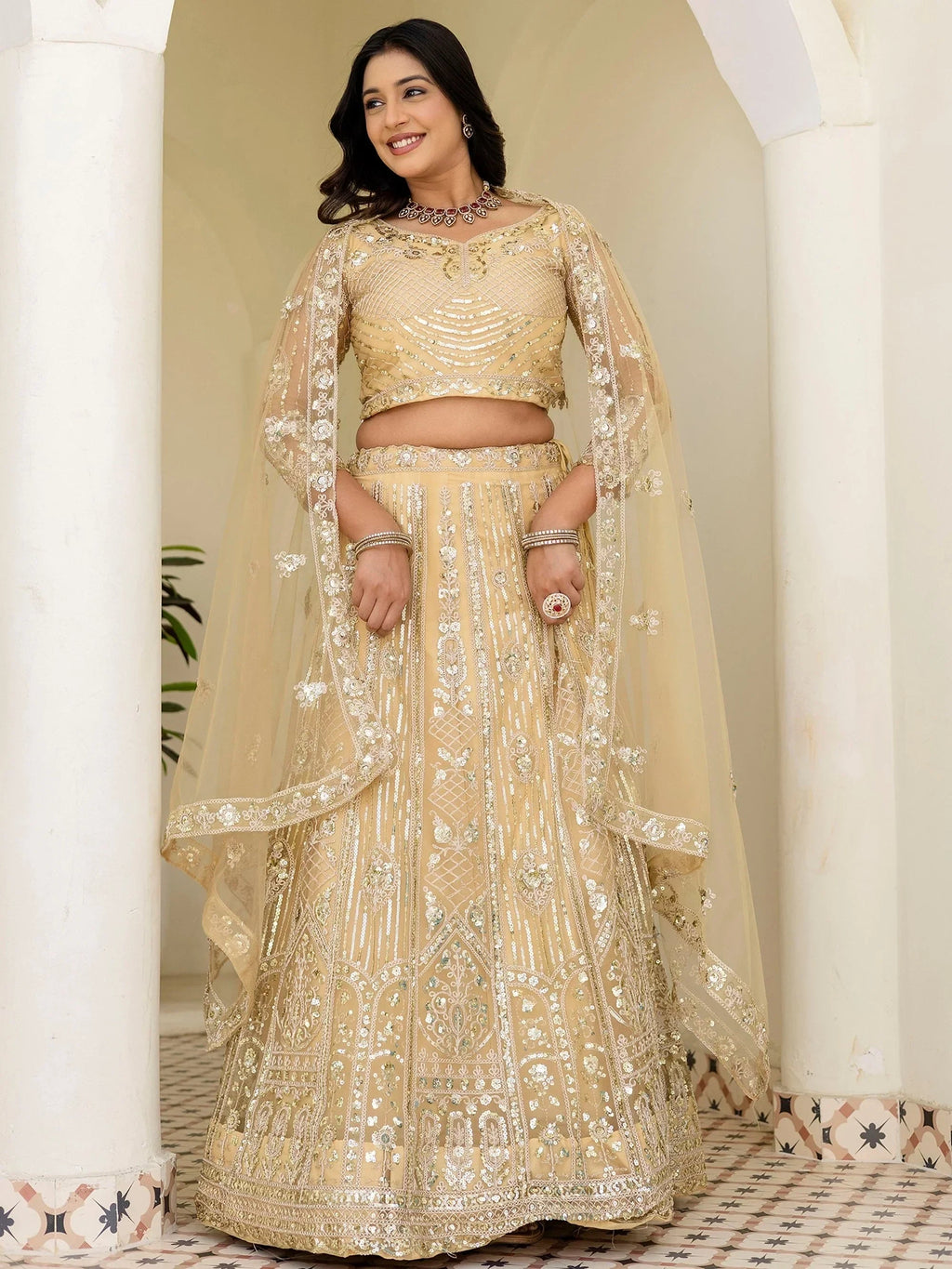 Cream Amazing Sequins Embroidered Net Party Wear Lehenga Choli