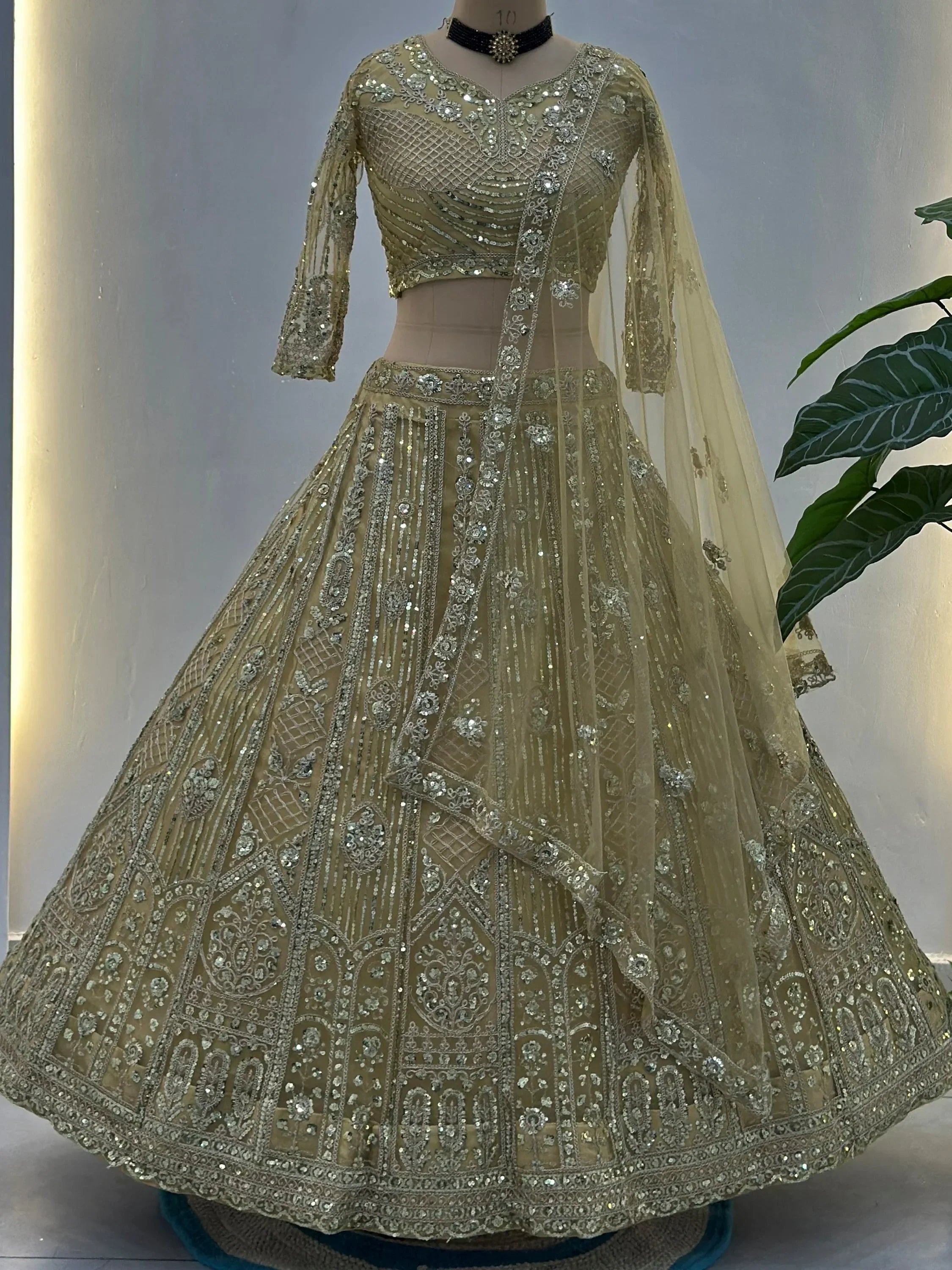 Cream Amazing Sequins Embroidered Net Party Wear Lehenga Choli