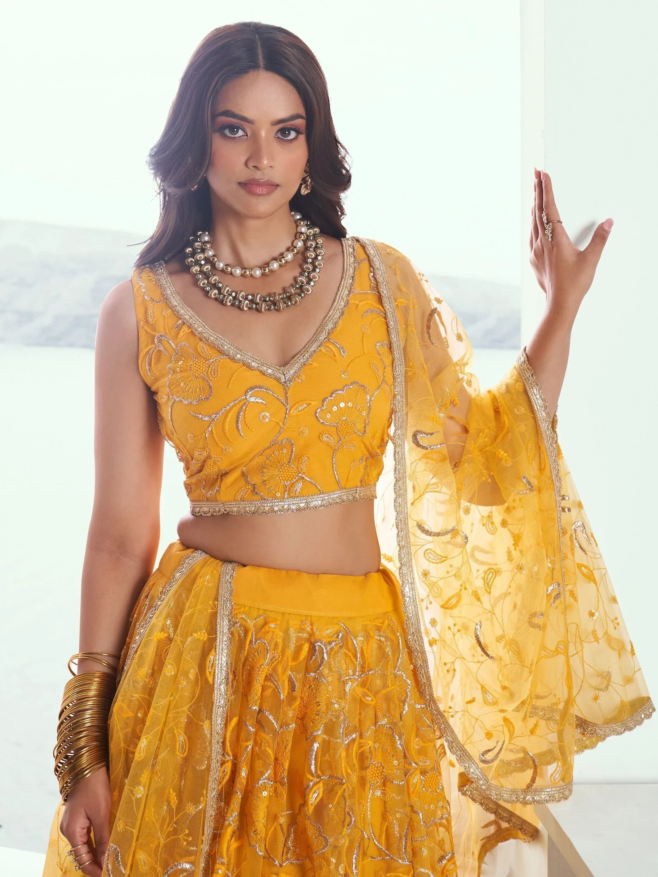 Endearing Yellow Color Embroidered Net Function Wear Lehenga Choli