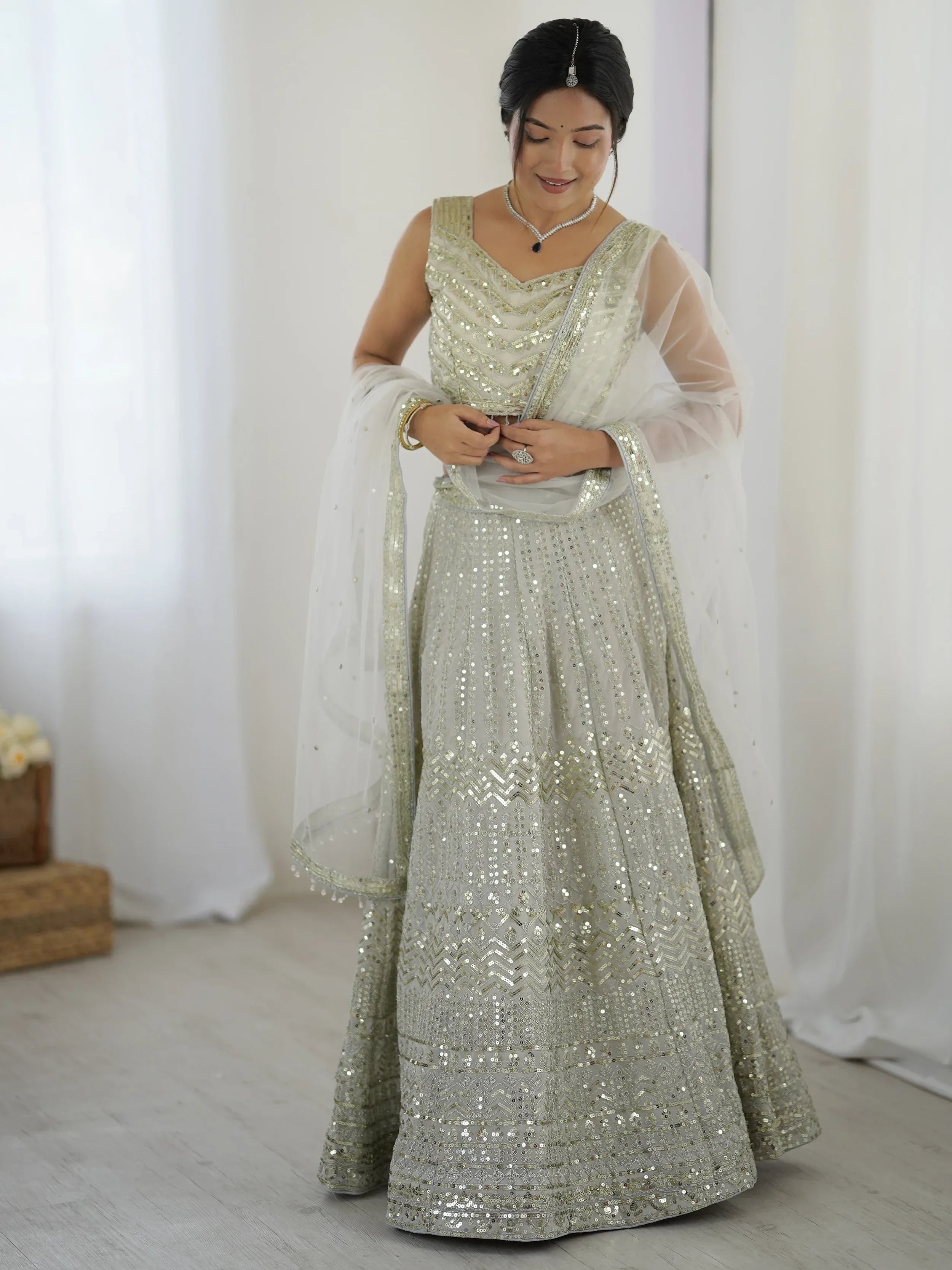 Luxurious Off White Georgette Sequins Bridesmaid Lehenga Choli
