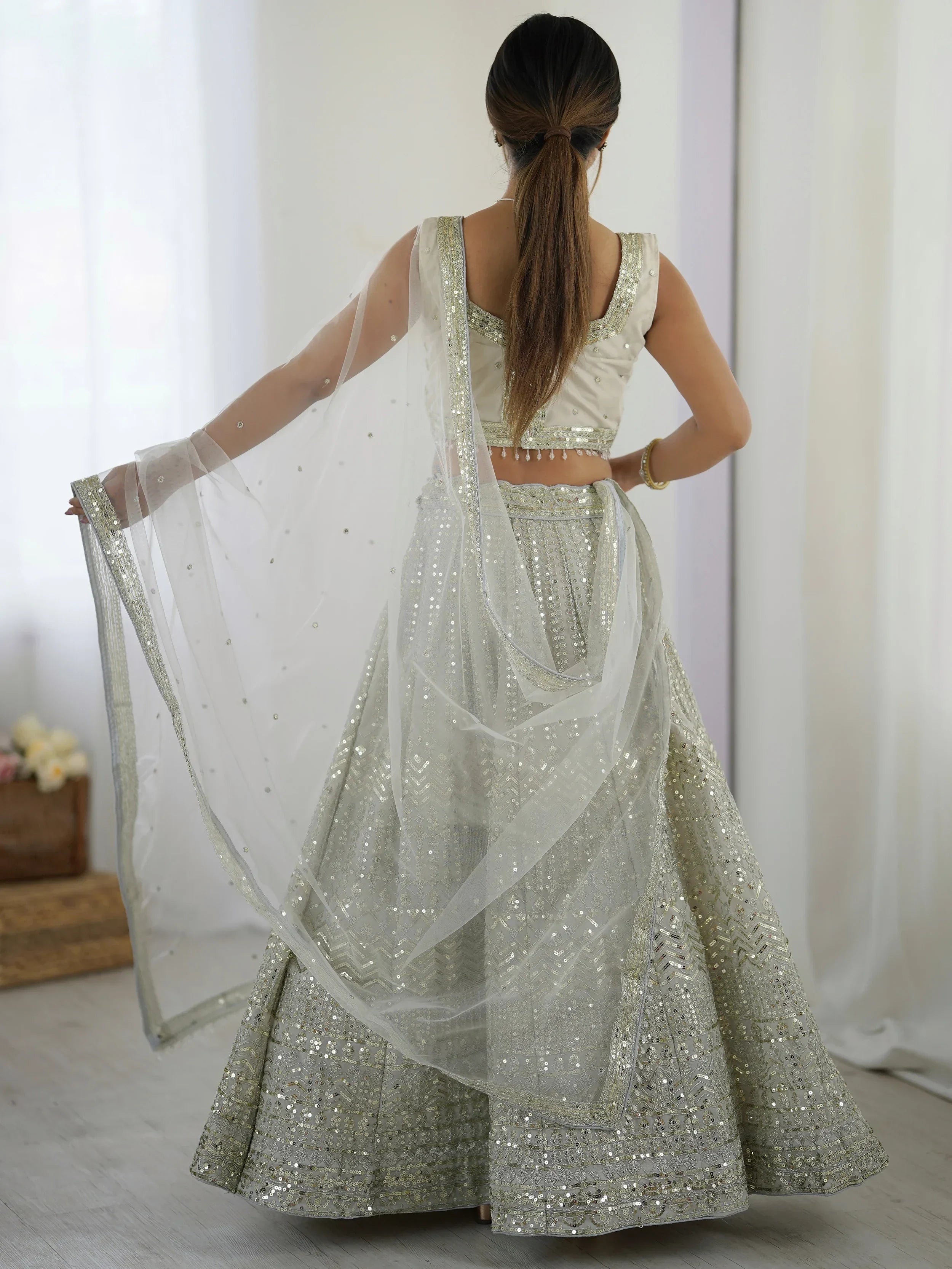 Luxurious Off White Georgette Sequins Bridesmaid Lehenga Choli