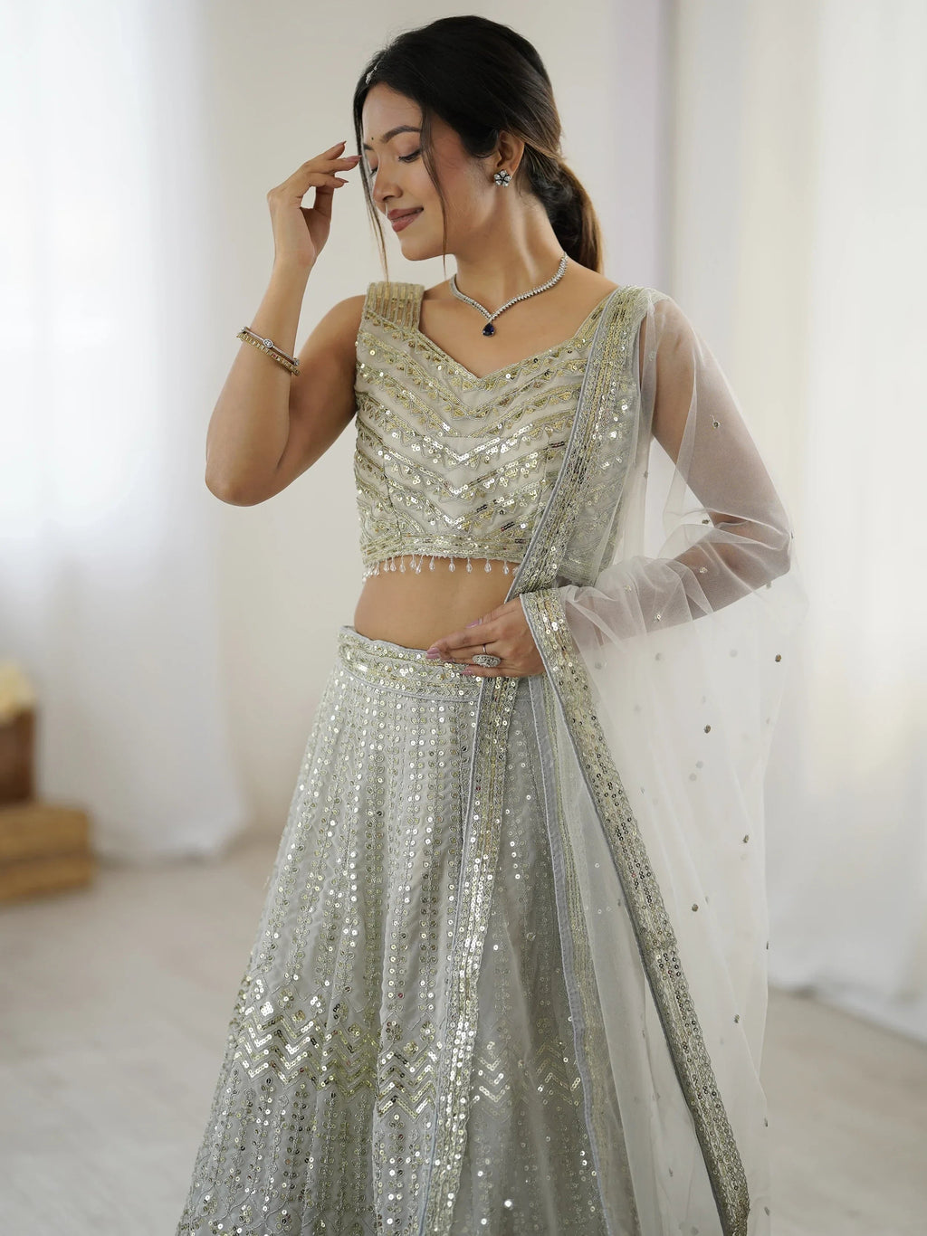 Luxurious Off White Georgette Sequins Bridesmaid Lehenga Choli