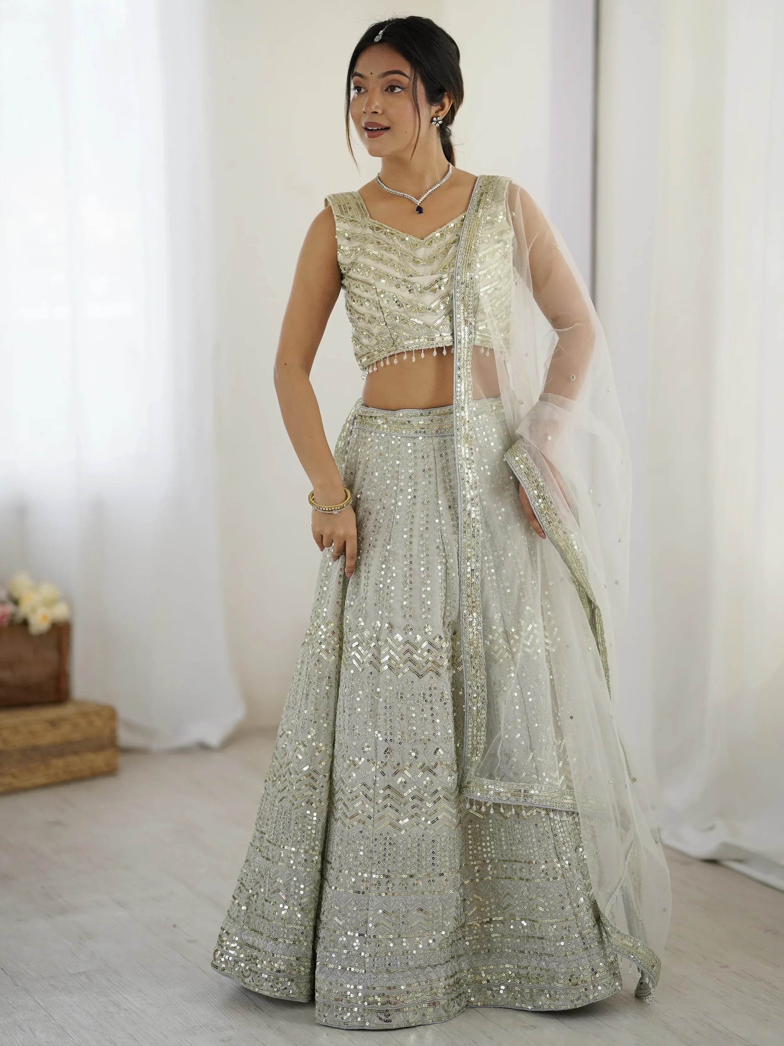 Luxurious Off White Georgette Sequins Bridesmaid Lehenga Choli