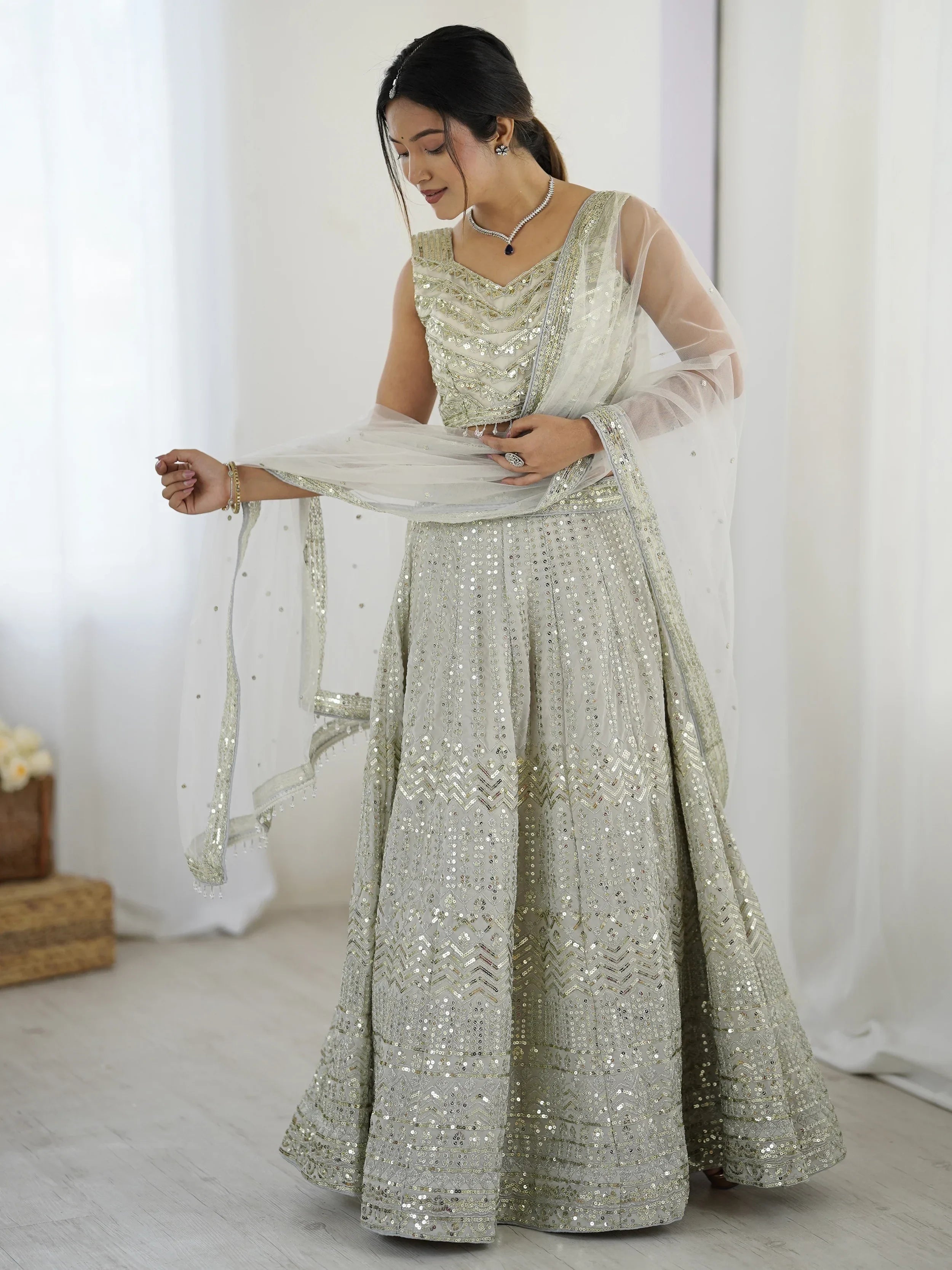 Luxurious Off White Georgette Sequins Bridesmaid Lehenga Choli